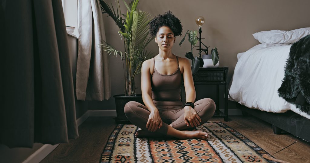 black woman is meditating before sleep