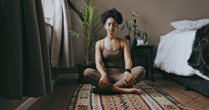 black woman is meditating before sleep