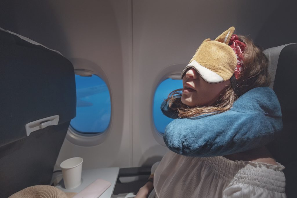 woman is sleeping on a plane
