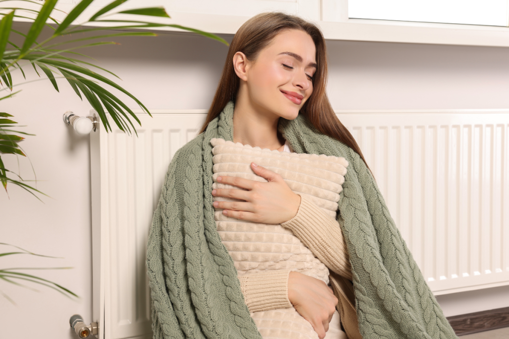 woman is holding a heating pillow